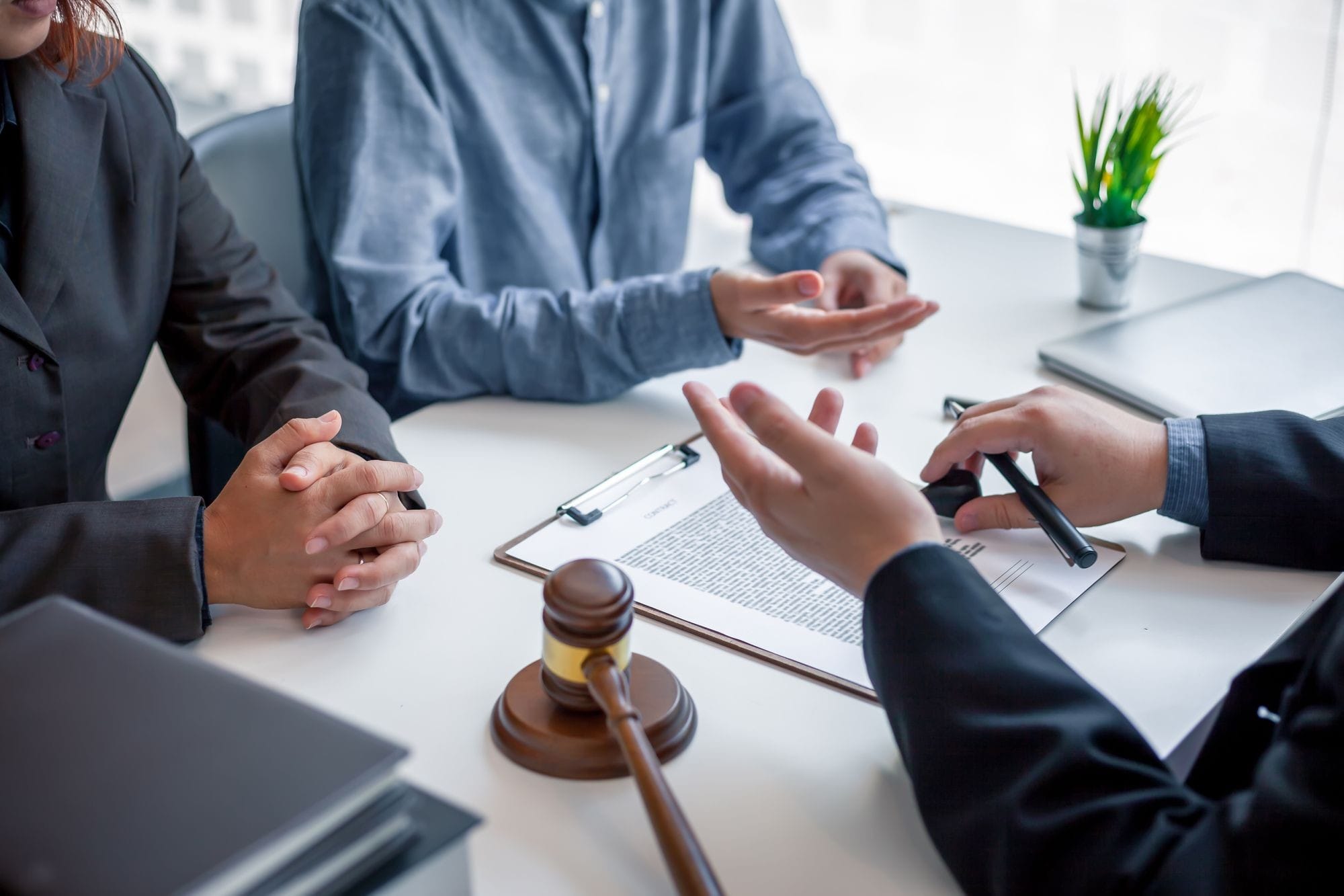 Clients And Lawyer Discuss The Contract Document